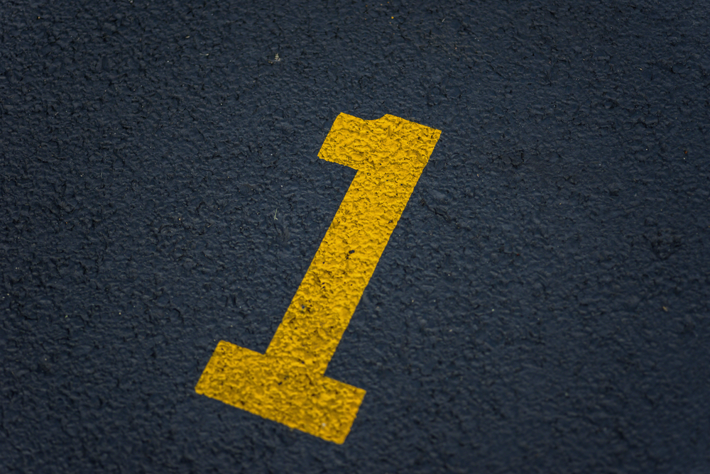 Stenciled,Number,1,One,In,Yellow,Paint,On,Blacktop,In